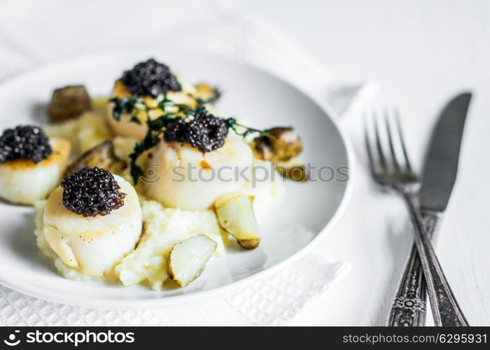 Scallops with black caviar