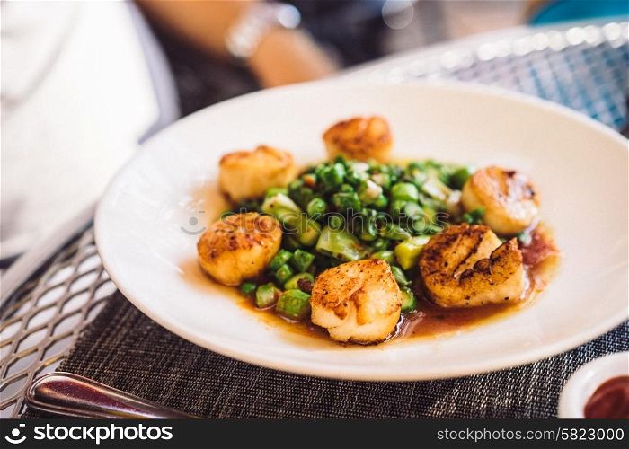 Scallops with vegetables outdoors