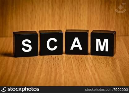 Scam, fraud text on black block, technology security concept