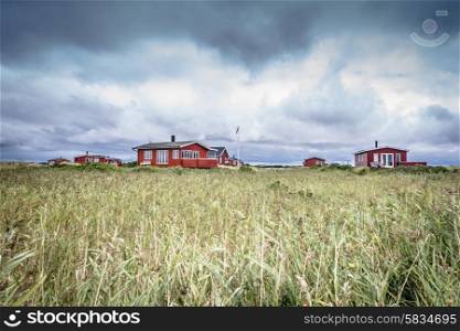 Scandinavian summer cabins in stormy weather