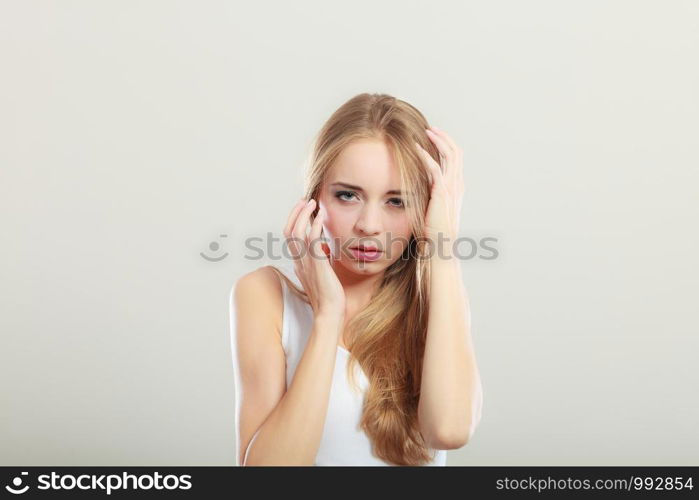 Scared afraid young woman on gray background