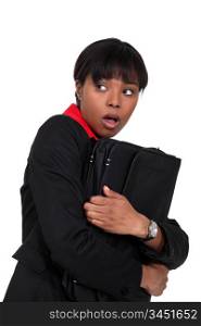 Scared businesswoman clutching folder