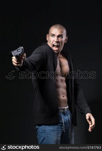 scared man shooting gun isolated on black background