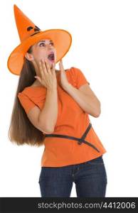 Scared woman in Halloween hat looking on copy space
