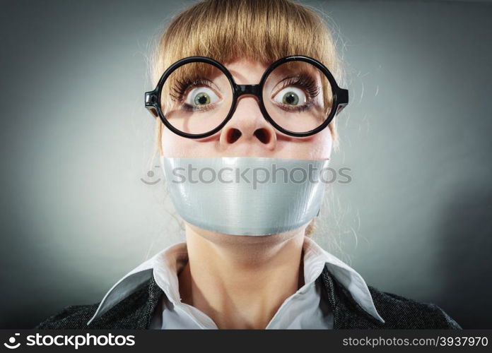 Scared woman with mouth taped shut. Afraid young girl with duct tape on lips. Censorship and freedom of speech concept.. Scared woman with mouth taped shut. Censorship.