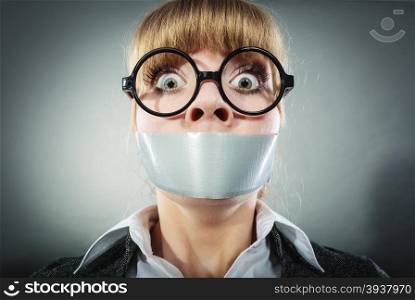 Scared woman with mouth taped shut. Afraid young girl with duct tape on lips. Censorship and freedom of speech concept.. Scared woman with mouth taped shut. Censorship.