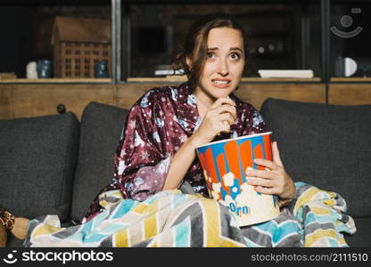 scared young woman watching television