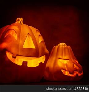 Scary carved glowing gourd on dark red background, creepy festive decoration, magic night, Halloween holiday concept