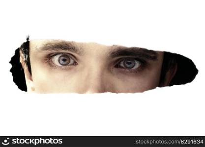 Scary eyes of a man spying through a hole
