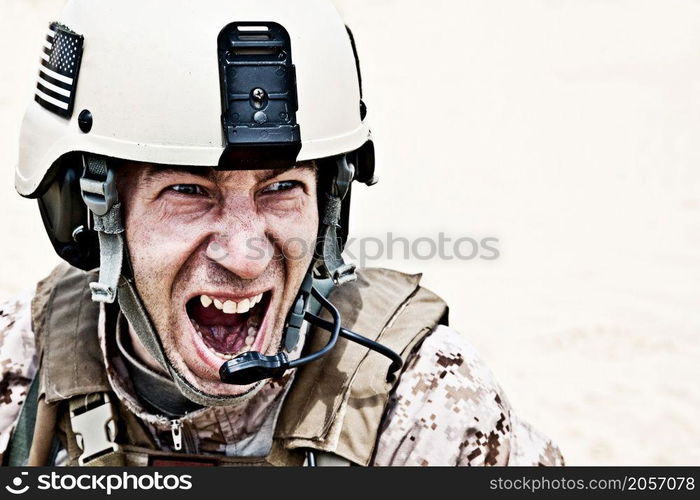 Scary face of US marine in the marpat uniform showing teeth