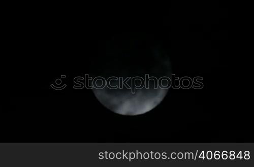 Scary Full Moon in a Cloudy Night. Very detailed lunar surface with its valleys and craters. Suitable for fear, scary and terror scenes. Awesome full moon. Night of wolf, Halloween night, nightmare.