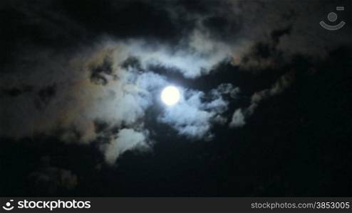 Scary Full Moon in a Cloudy Night.Very detailed lunar surface with its valleys and craters.Suitable for fear, scary and terror scenes.Awesome full moon. Night of wolf, Halloween night, nightmare.