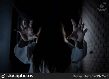 Scary ghost in white dress halloween theme focus hand.