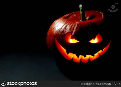 Scary smiling Halloween pumpkin on dark background. Halloween pumpkin