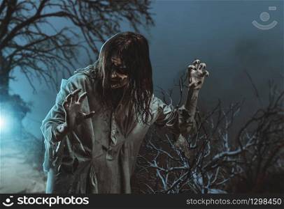 Scary zombie against the background of a tree. Halloween.. Scary zombie. Halloween.
