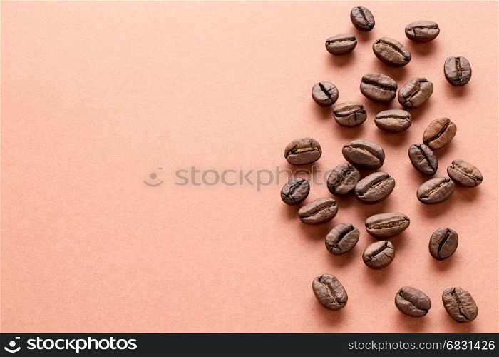 Scattered coffee beans. Heap of roasted brown coffee beans with copy space