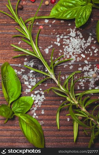 Scattered fresh basil and rosemary, sea salt and dry peppercorns