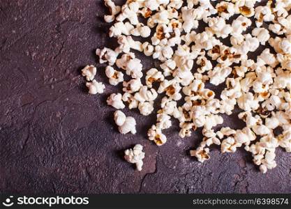 Scattered fresh popcorn on the table, close up top view. Scattered popcorn top view
