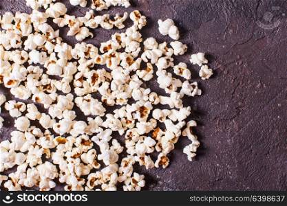 Scattered fresh popcorn on the table, close up top view. Scattered popcorn top view