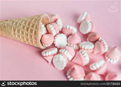 Scattered pink and white decor for baking, meringue in waffle cookies, a place for advertising. Scattered pink and white decor for baking, meringue in waffle cookies