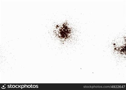 Scattered powder. Abstract image with brown powder on white background