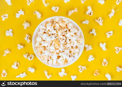 Scattered tasty cheese popcorn in bowl isolated on yellow background. Wallpaper, banner, header with copy space for text