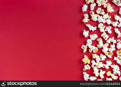 Scattered tasty cheese popcorn isolated on red background. Top view, flat lay , banner, wallpaper, border with copy space
