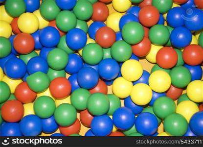 scattered varicoloured plastic balls - toys.