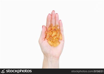 Scattering of transparent yellow pills. Handful of capsules in palm of hand, close-up, isolated on white background. Capsules fish oil, omega 3. Healthy lifestyle, dietary nutritional supplements.. Scattering of transparent yellow pills. Handful of capsules in palm of hand, close-up, isolated on white background.
