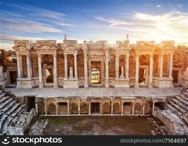 Scene and columns with sculptures of ancient amphitheater in Hieropolis. Unesco Cultural Heritage Monument. Pamukkale, Turkey. Scene and columns with sculptures of ancient amphitheater in Hieropolis