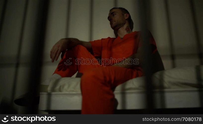 Scene of a depressed and tattooed inmate in prison