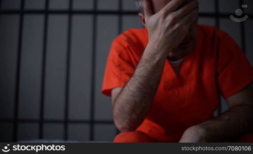 Scene of a depressed inmate crying in prison