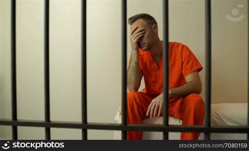 Scene of a disheartened inmate in prison