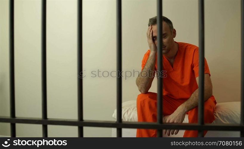 Scene of a moody inmate in prison on bed