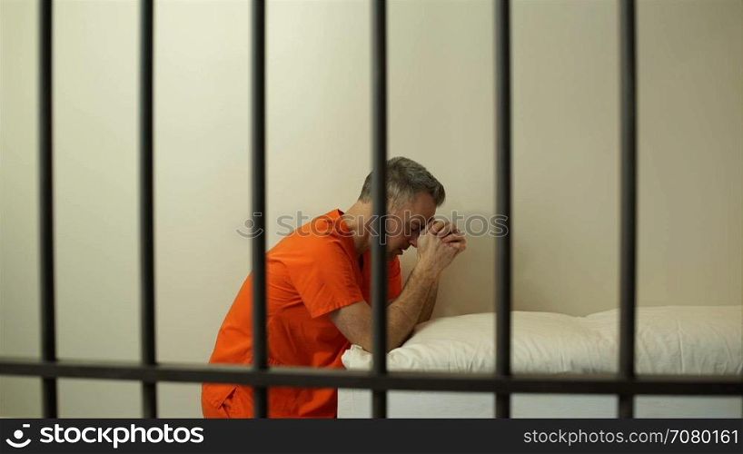 Scene of a prayerful inmate in prison