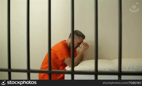 Scene of a prayerful inmate in prison