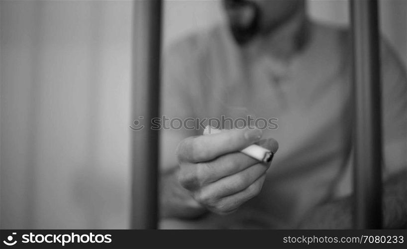 Scene of an inmate smoking in prison