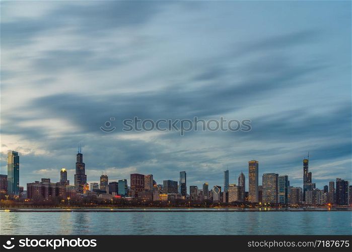 Scene of Chicago Cityscape river side along Lake Michigan at beautiful twilight time, Illinois, United States, Business Architecture and building with tourist concept