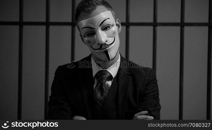 Scene of suited Anonymous hacker in prison (B/W Version)