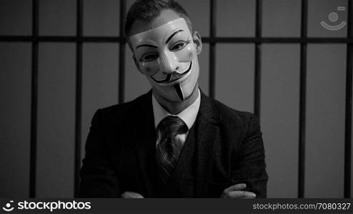 Scene of suited Anonymous hacker in prison (B/W Version)