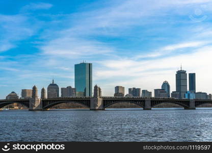 Scene of Train running over the Longfellow Bridge the charles river at the evening time, USA downtown skyline, Architecture and building with transportation concept