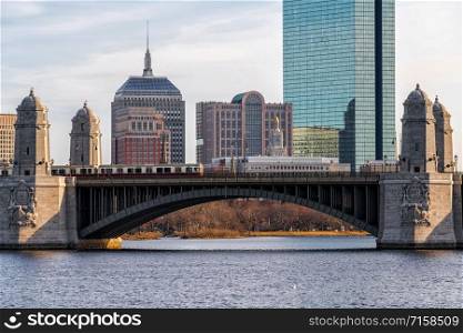 Scene of Train running over the Longfellow Bridge the charles river at the evening time, USA downtown skyline, Architecture and building with transportation concept