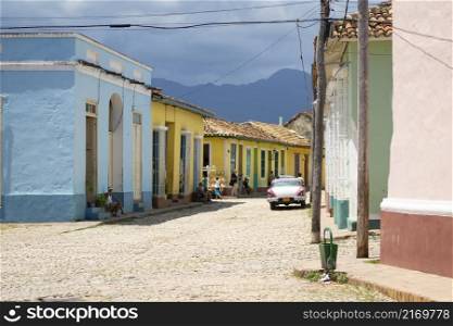 Scene on the street with colorful houses in the center of Trinidad, Cuba.