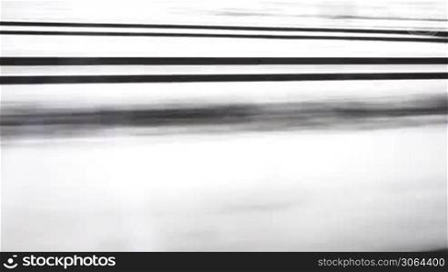 Scene shows very fast movement along railtracks, Szene zeigt eine Fahrt entlang einer Trasse an einem Wintertag