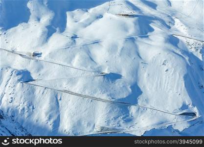 Scenery from the cabin ski lift at serpentine road on snowy slope (Tyrol, Austria).