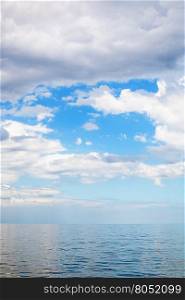 scenery of cumulus clouds over calm blue water Sea of Azov, Temryuk bay, Golubitskaya resort, Taman peninsula, Kuban, Russia