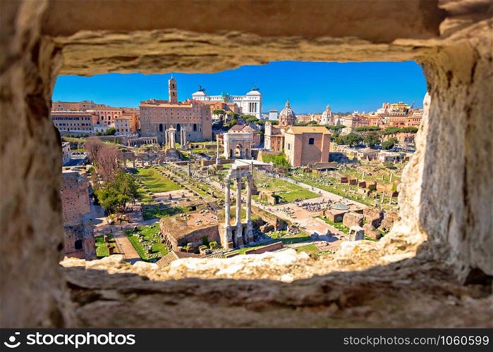 Scenic aerial stone window view over the ruins of the Roman Forum in Rome, capital of Italy