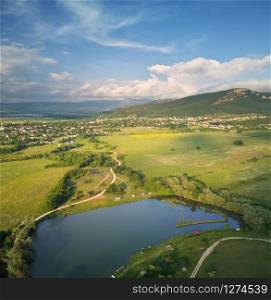 Scenic aerial view of beautiful landscape of the valley Hills and lake on sunset.