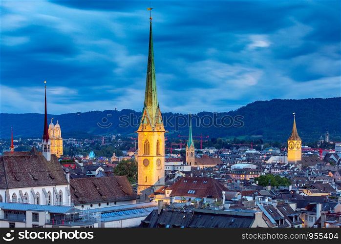 Scenic aerial view of the city at sunset. Zurich. Switzerland.. Zurich. Aerial view of the city in night lighting.