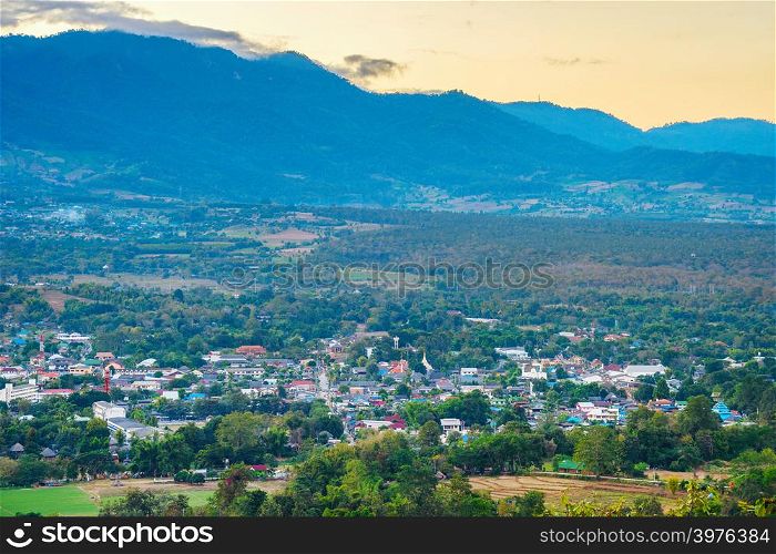 Scenic asian landscape after sunset with remote village and fields in mountain valley, Pai, Thailand